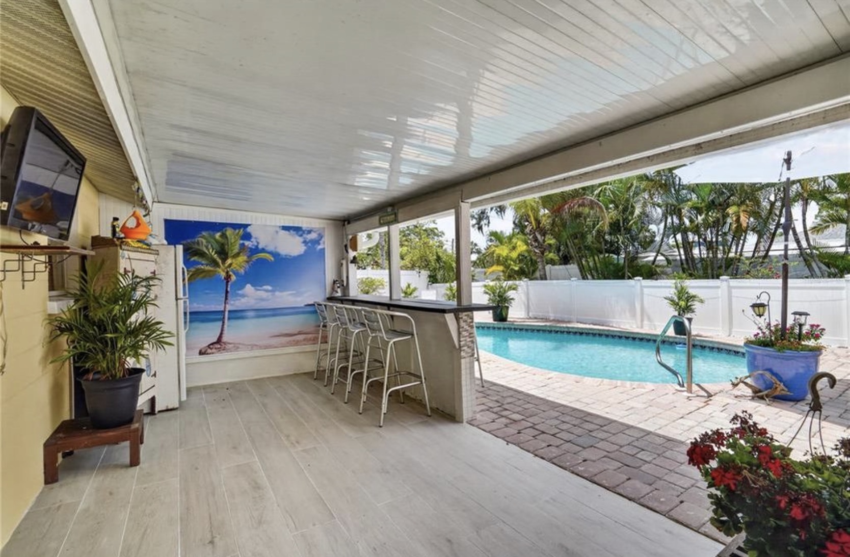 Covered outdoor bar overlooking the pool